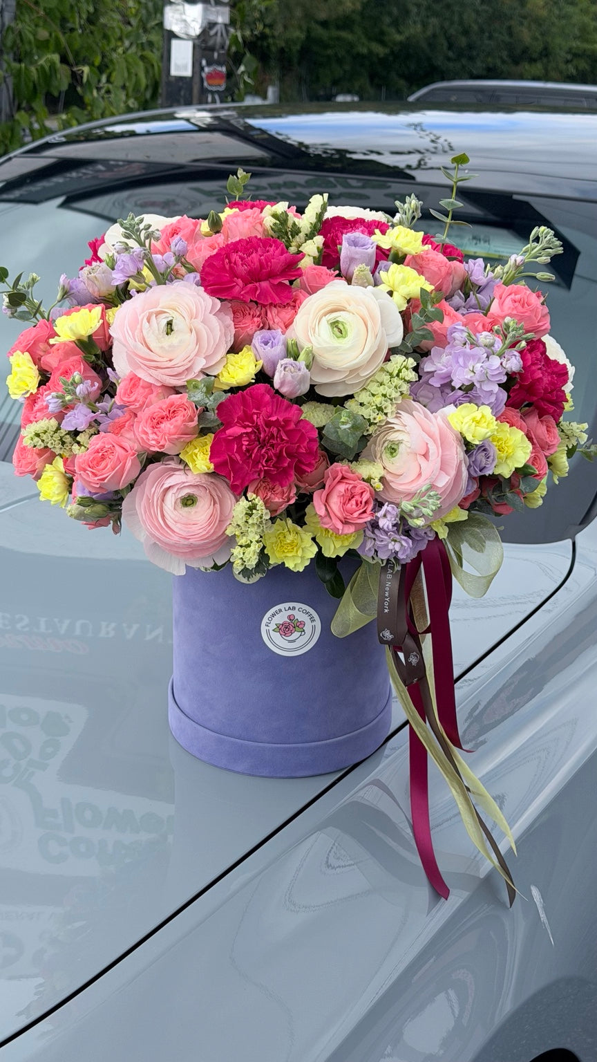 Dopamine Bloom Flower Box — Large size pictured, with ranunculus, coral spray roses, fuchsia carnations and lavender flowers