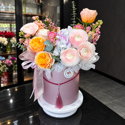 Luxury in Bloom flower box with full arrangement shown in a square frame