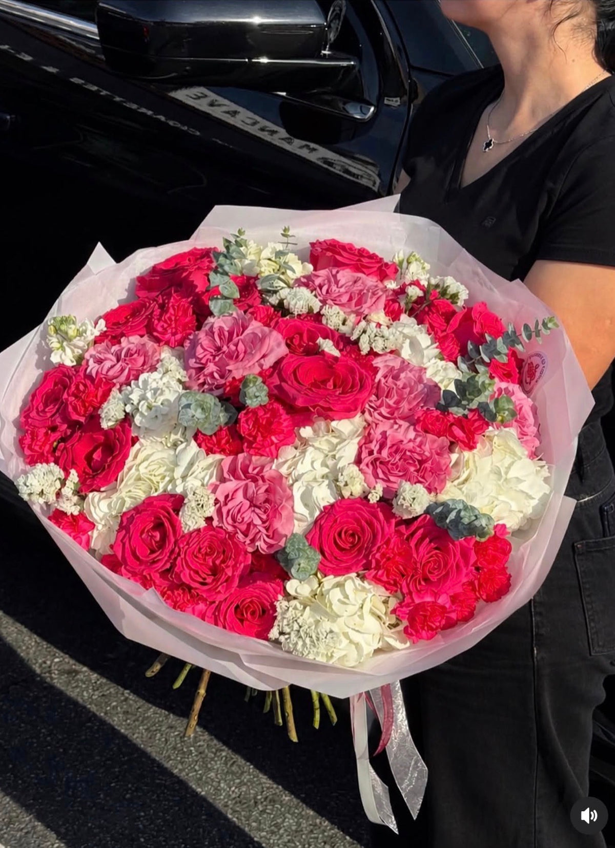 Pink Majesty Bouquet with hot pink and lavender-pink roses, white hydrangeas, mini carnations and eucalyptus