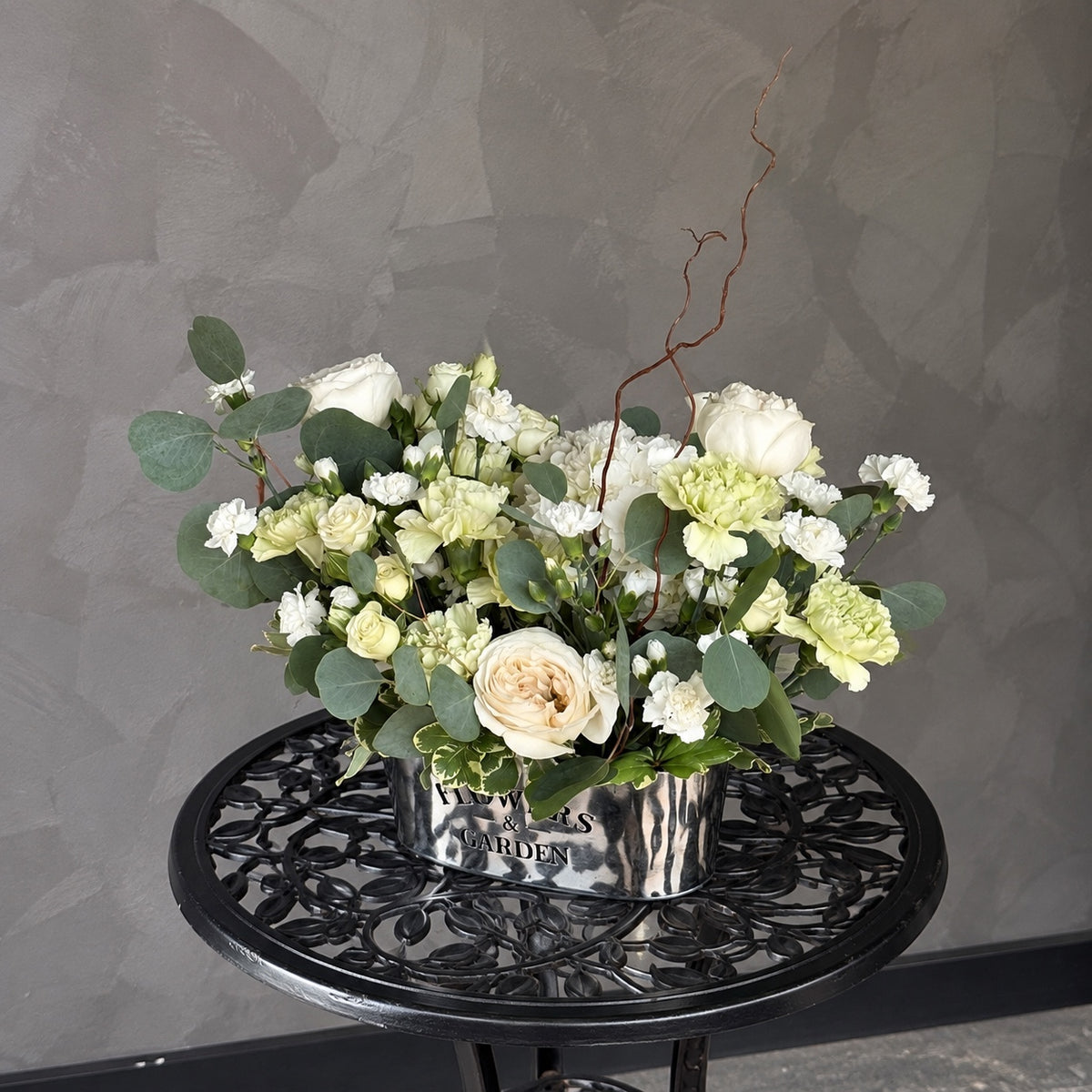 Quiet Elegance white and green corporate flower arrangement in a silver container