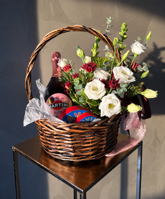 The Gratitude Basket with black caviar and fresh seasonal flowers; bottle shown for styling inspiration only and not included.