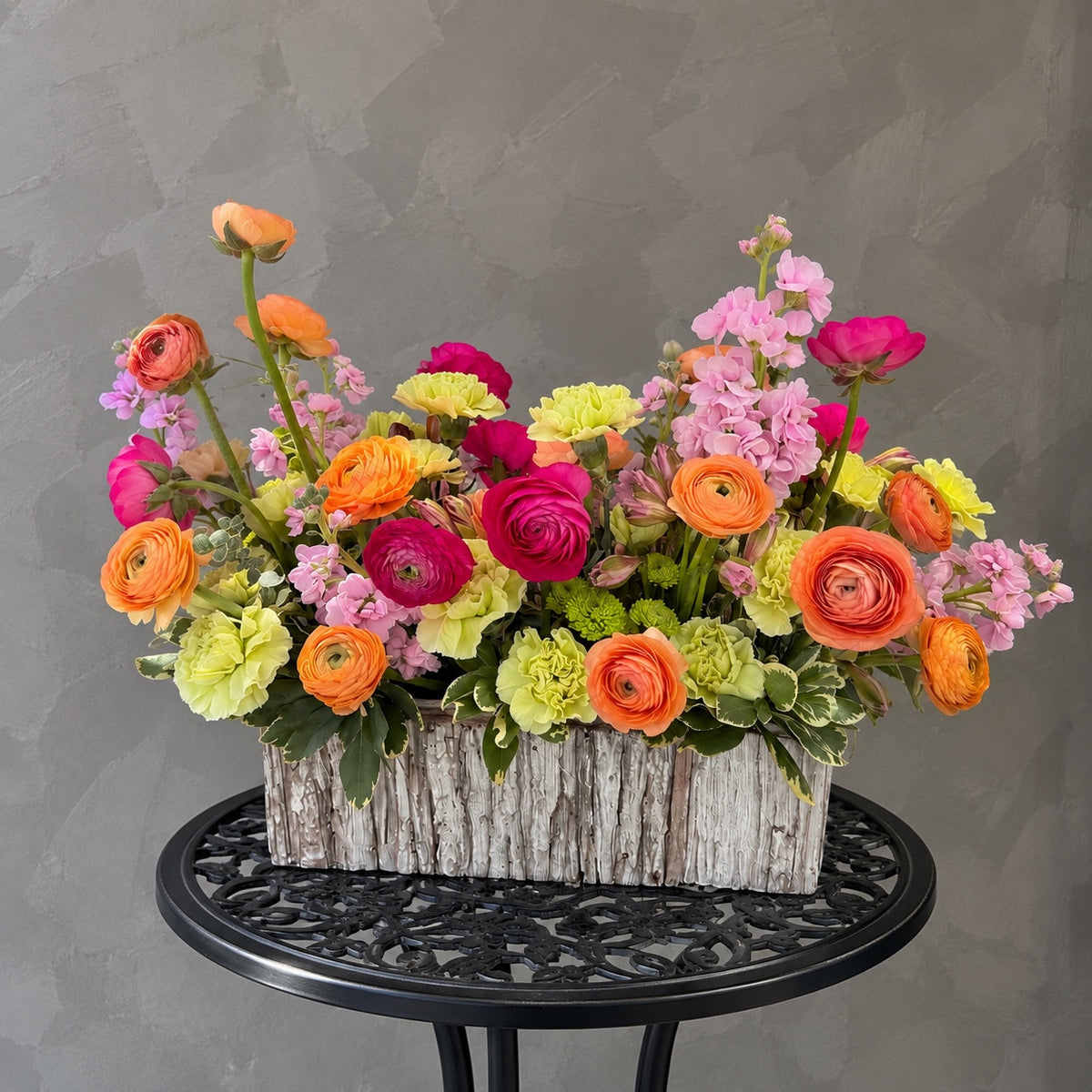 Vibrant Impression corporate flower arrangement with colorful ranunculus and seasonal flowers